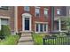 Brick front exterior of townhome with steps leading to the entrance and a small patio area at 9558 Oakley Dr, Indianapolis, IN 46260