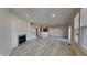 Open living room with fireplace and adjacent kitchen at 9558 Oakley Dr, Indianapolis, IN 46260