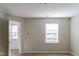 Empty bedroom with window and doorway leading to another room at 10938 Delphi Dr, Camby, IN 46113