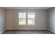 Empty bedroom with two large windows and neutral-colored walls at 10938 Delphi Dr, Camby, IN 46113