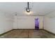 Garage interior with shelving, concrete flooring, and a door leading to another room at 10938 Delphi Dr, Camby, IN 46113