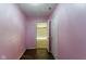 Pink hallway leading to an open garage door at 10938 Delphi Dr, Camby, IN 46113
