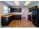 Bright kitchen featuring dark brown cabinets and wood-look flooring at 10938 Delphi Dr, Camby, IN 46113