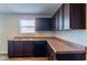 Kitchen with dark brown cabinets, granite countertops, and wood-look flooring at 10938 Delphi Dr, Camby, IN 46113