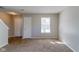 Living room with neutral paint, carpeted floors, and entryway at 10938 Delphi Dr, Camby, IN 46113