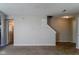 Living area with neutral paint, carpeted flooring, and staircase at 10938 Delphi Dr, Camby, IN 46113