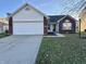 Brick and vinyl ranch home with attached garage and landscaped lawn at 12351 Tuckaway Ct, Fishers, IN 46037