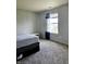 Cozy bedroom with a large window and gray carpeting at 5236 Bluff View Dr, Indianapolis, IN 46217