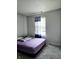 Cozy bedroom with a queen-size bed, window, and neutral color palette at 5236 Bluff View Dr, Indianapolis, IN 46217