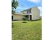 Two-story yellow house with a small tree and lawn at 5236 Bluff View Dr, Indianapolis, IN 46217