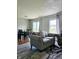 Open living and dining area with gray sofas and hardwood floors at 5236 Bluff View Dr, Indianapolis, IN 46217