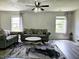 Living room with gray sofas, hardwood floors, and two windows at 5236 Bluff View Dr, Indianapolis, IN 46217