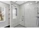 Walk-in shower with marble-style tile and glass door at 6531 Hunters N Rdg, Zionsville, IN 46077