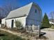 Spacious two-car garage with a charming gambrel roof and a quaint picket fence at 8418 S State Road 39, Clayton, IN 46118