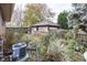 Backyard with detached garage and overgrown landscaping at 1330 N Bosart Ave, Indianapolis, IN 46201