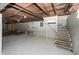 Unfinished basement with a sink and partial staircase at 1330 N Bosart Ave, Indianapolis, IN 46201