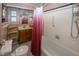 Bathroom with a tub, wooden vanity, and tiled walls at 1330 N Bosart Ave, Indianapolis, IN 46201