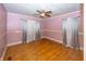 Empty bedroom with hardwood floors and pink walls at 1330 N Bosart Ave, Indianapolis, IN 46201