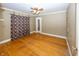 Bedroom with hardwood floors and patterned curtains at 1330 N Bosart Ave, Indianapolis, IN 46201