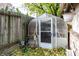 Small greenhouse with various gardening supplies at 1330 N Bosart Ave, Indianapolis, IN 46201