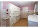 Kitchen with vintage white cabinets and a small countertop at 1330 N Bosart Ave, Indianapolis, IN 46201