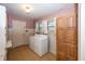 Laundry room with washer, dryer, and wooden cabinets at 1330 N Bosart Ave, Indianapolis, IN 46201