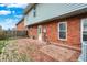 Brick patio and exterior access to home with a fenced yard at 1709 Queensbridge Dr, Indianapolis, IN 46219