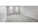 Bright bedroom with gray walls, gray carpeting, and two windows at 1709 Queensbridge Dr, Indianapolis, IN 46219