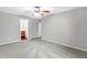 Main bedroom with gray carpet, ceiling fan and en-suite bathroom at 1709 Queensbridge Dr, Indianapolis, IN 46219