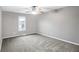 Spacious bedroom with gray carpeting and ceiling fan at 1709 Queensbridge Dr, Indianapolis, IN 46219