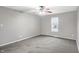 Spacious bedroom with gray carpeting and ceiling fan at 1709 Queensbridge Dr, Indianapolis, IN 46219