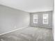 Spacious living room with neutral gray walls and gray carpeting at 1709 Queensbridge Dr, Indianapolis, IN 46219