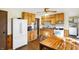 Kitchen with wood cabinets, appliances, and a dining area at 5 Woodridge Ct, Whiteland, IN 46184
