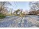 Spacious backyard with mature trees, lightly covered in snow at 80 S Mickley Ave, Indianapolis, IN 46241