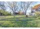 Large backyard with mature trees, providing ample space and privacy at 80 S Mickley Ave, Indianapolis, IN 46241