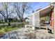 Rustic backyard with wooden deck, lattice, and mature trees at 80 S Mickley Ave, Indianapolis, IN 46241