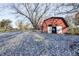 Rustic red barn nestled in backyard with snow on the ground at 80 S Mickley Ave, Indianapolis, IN 46241