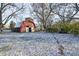 Rustic red barn in backyard setting with light dusting of snow at 80 S Mickley Ave, Indianapolis, IN 46241