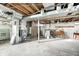 Unfinished basement with laundry hookups and storage space at 80 S Mickley Ave, Indianapolis, IN 46241
