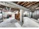 Unfinished basement with high ceilings, storage shelving, and exposed utilities at 80 S Mickley Ave, Indianapolis, IN 46241