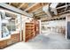 Unfinished basement featuring wooden shelving and a staircase at 80 S Mickley Ave, Indianapolis, IN 46241