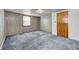 Spacious bedroom with wood-paneled walls and wall-to-wall carpeting at 80 S Mickley Ave, Indianapolis, IN 46241