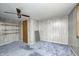 Cozy bedroom with wood-paneled walls, built-in shelving, and carpeting at 80 S Mickley Ave, Indianapolis, IN 46241