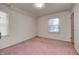 Simple bedroom with pink carpet and a window at 80 S Mickley Ave, Indianapolis, IN 46241