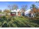 Brick house with a white upper story, detached garage and large backyard at 80 S Mickley Ave, Indianapolis, IN 46241