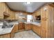 Wood kitchen cabinets, tile backsplash, and double sink at 80 S Mickley Ave, Indianapolis, IN 46241