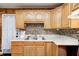 Wood kitchen cabinets and tile backsplash at 80 S Mickley Ave, Indianapolis, IN 46241