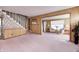 Spacious living room features pink carpet, wood paneling, and a fireplace at 80 S Mickley Ave, Indianapolis, IN 46241