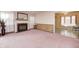 Bright living room with pink carpet and a fireplace at 80 S Mickley Ave, Indianapolis, IN 46241