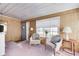 Charming sunroom with wood paneling and window seat at 80 S Mickley Ave, Indianapolis, IN 46241